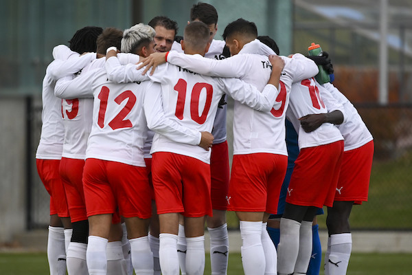 Soccer players standing in a huddle