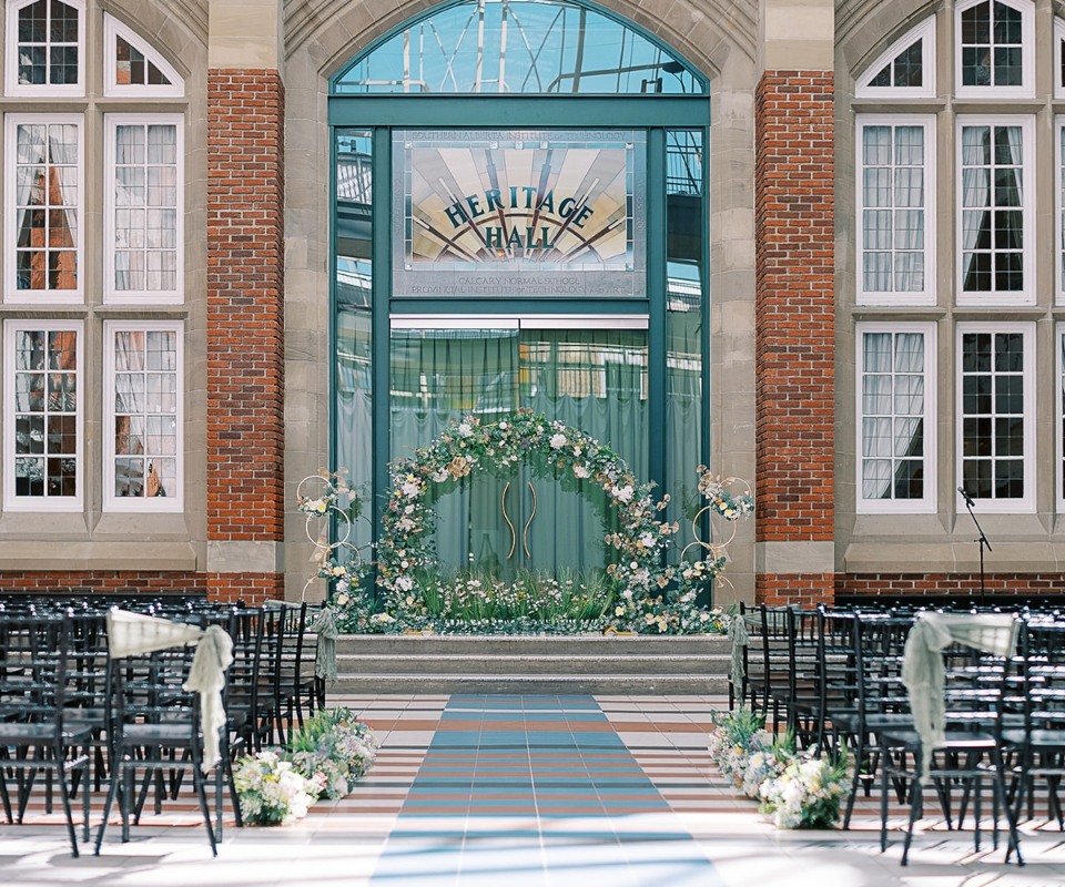 Elegant wedding venue entrance featuring floral decorations and seating arrangements.