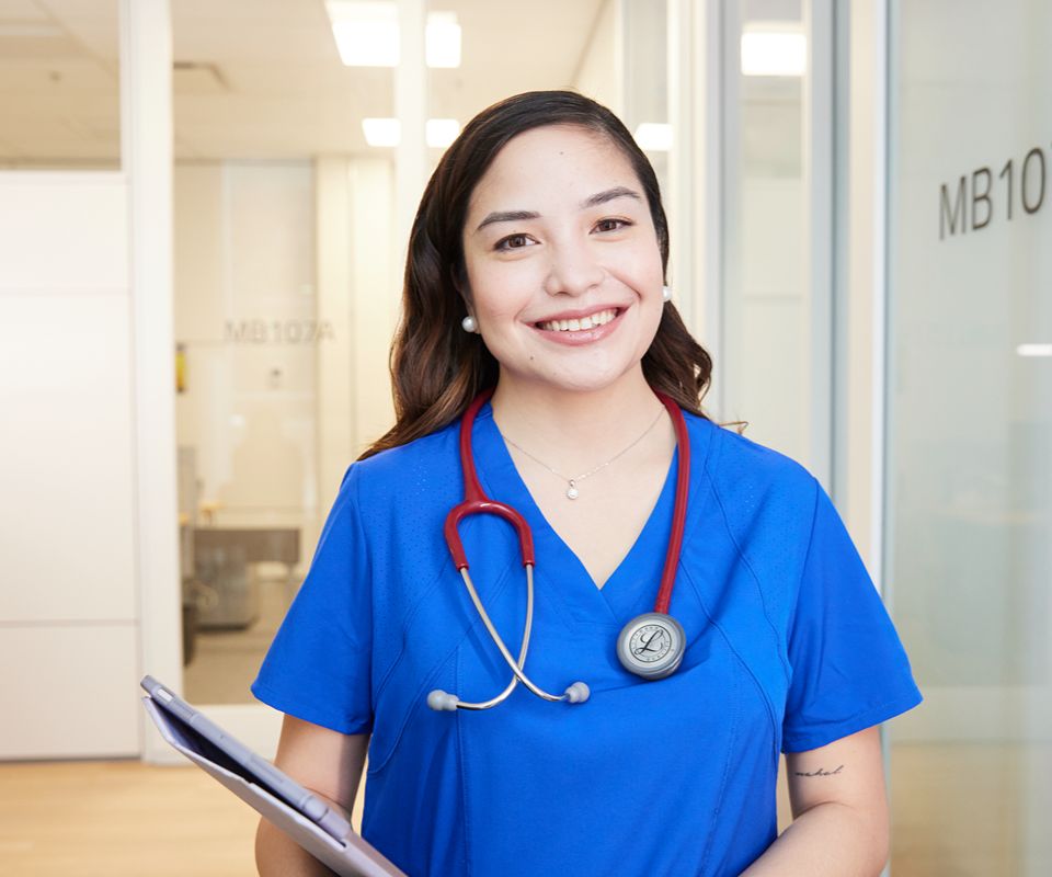Person in blue medical scrubs with a stethoscope