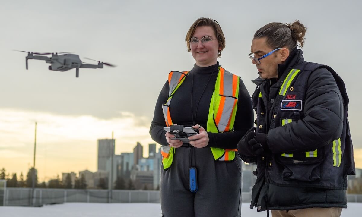 An instructor and a student working with a drone