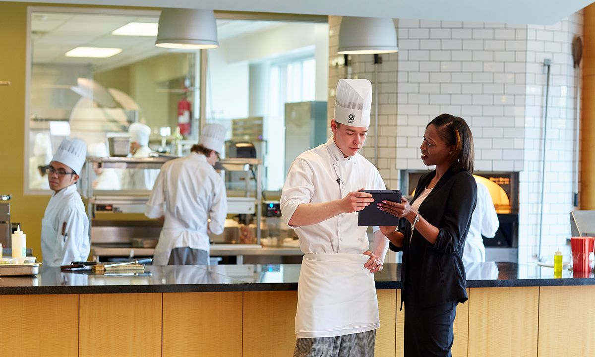 chef consulting with professional in commercial kitchen