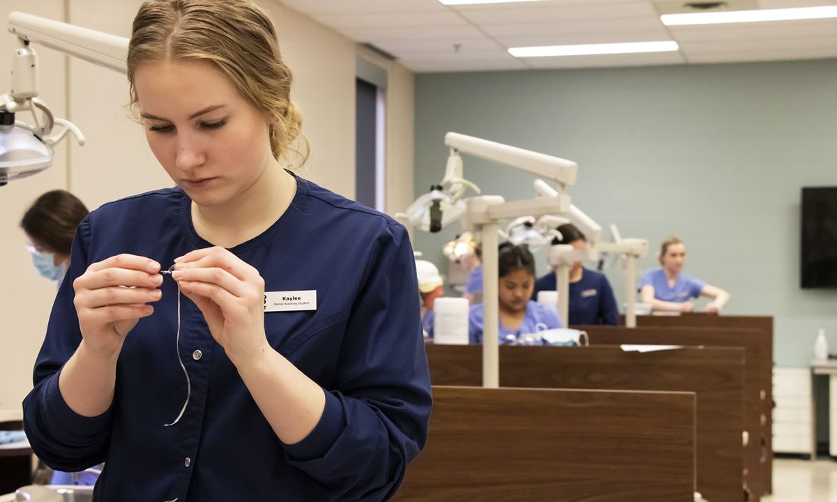 dental technician preparing tools in training clinic