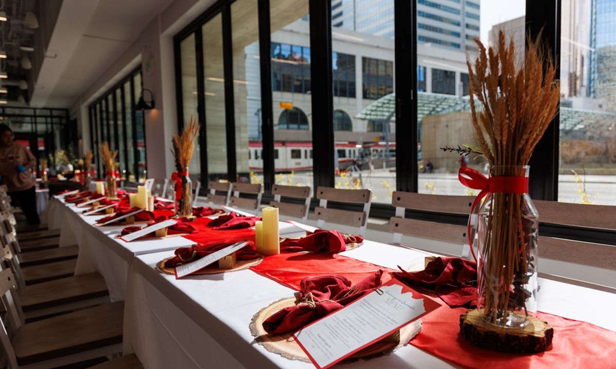 event dining table with red decor and wheat centerpieces