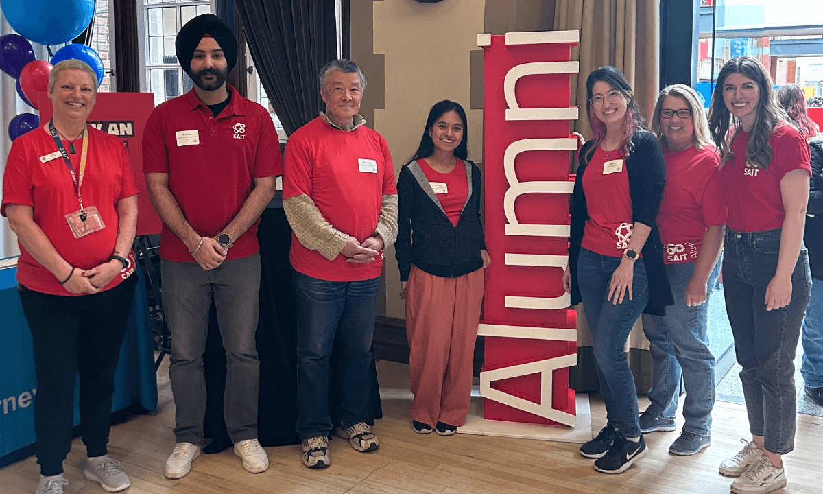group in red shirts posing for photo