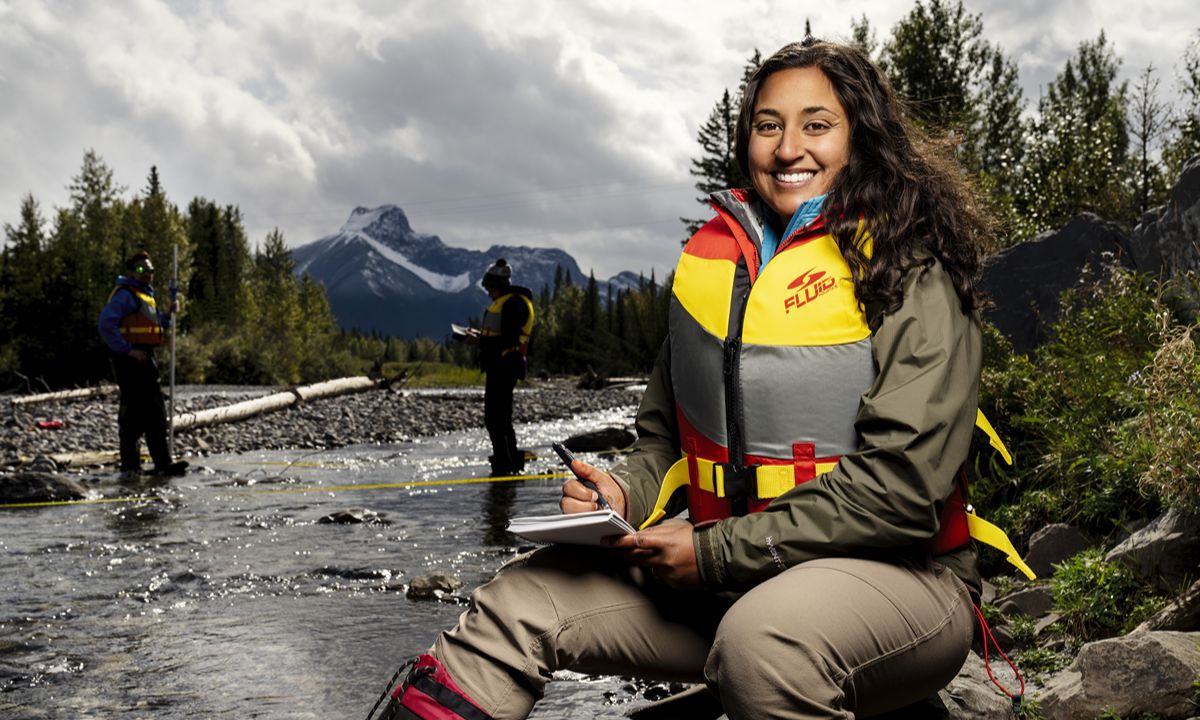 lady in life jacket holding pen and book