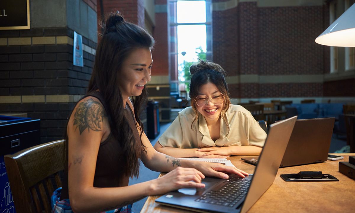 one student on laptop one looking at screen