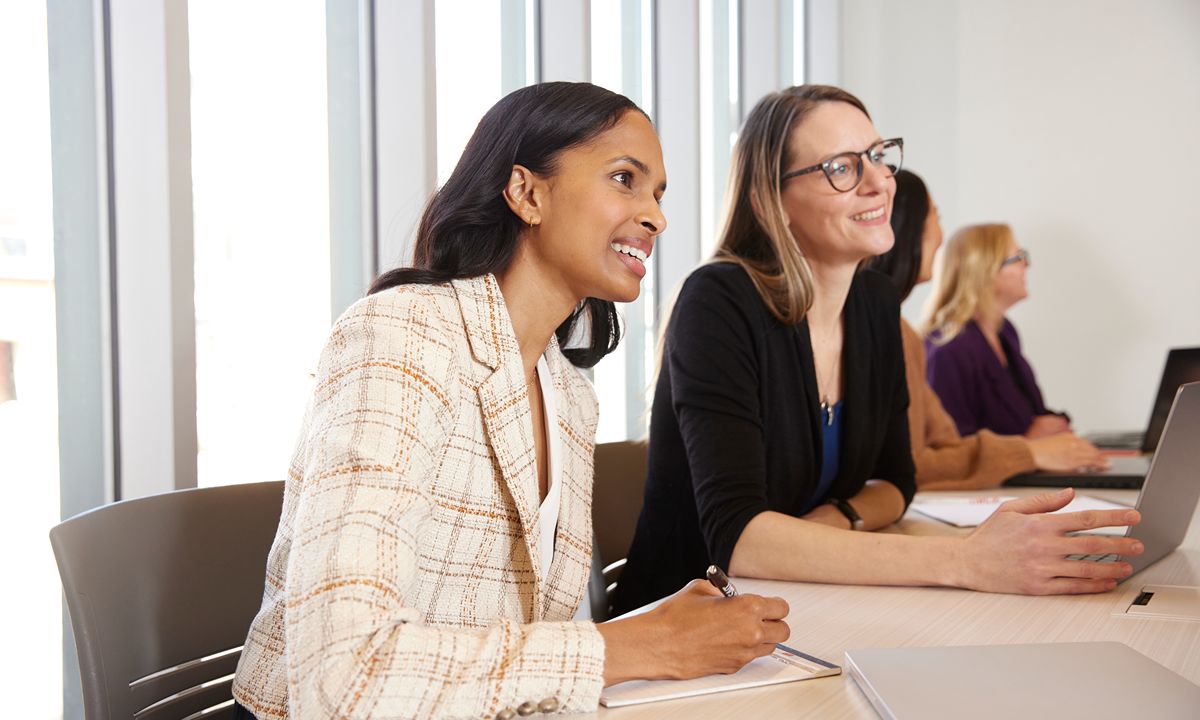 people taking notes during meeting