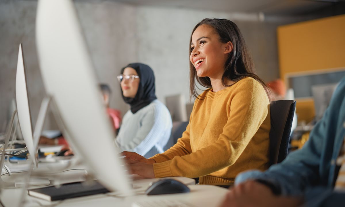 people working on computer in office space