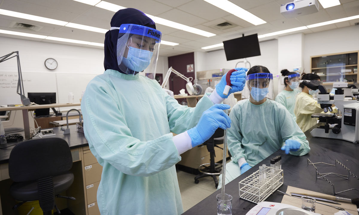 lab workers in protective gear conducting tests