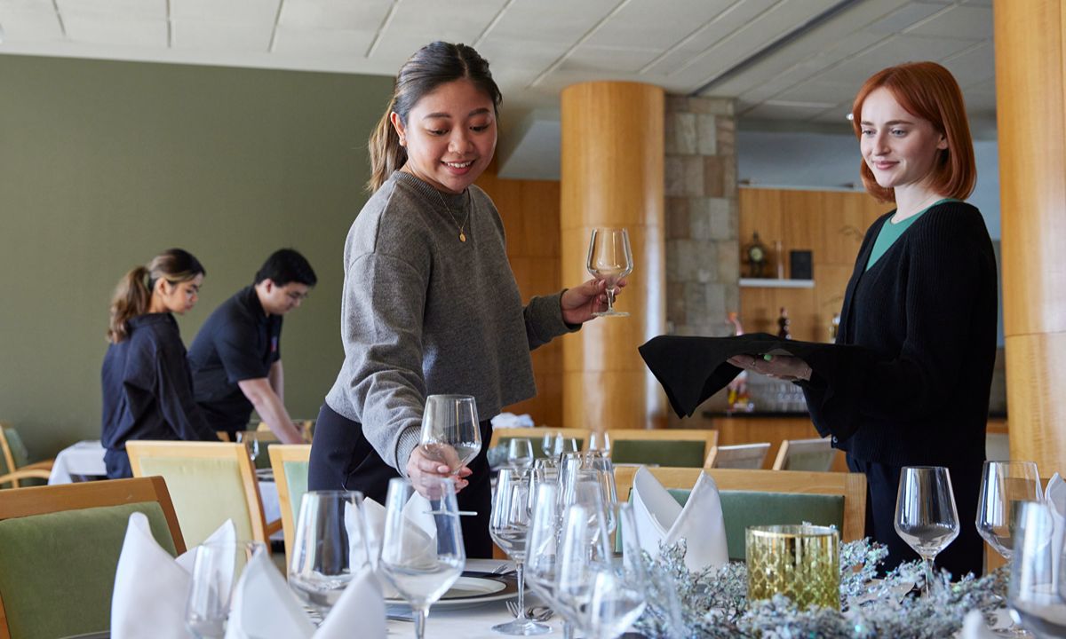 restaurant staff setting table for formal event