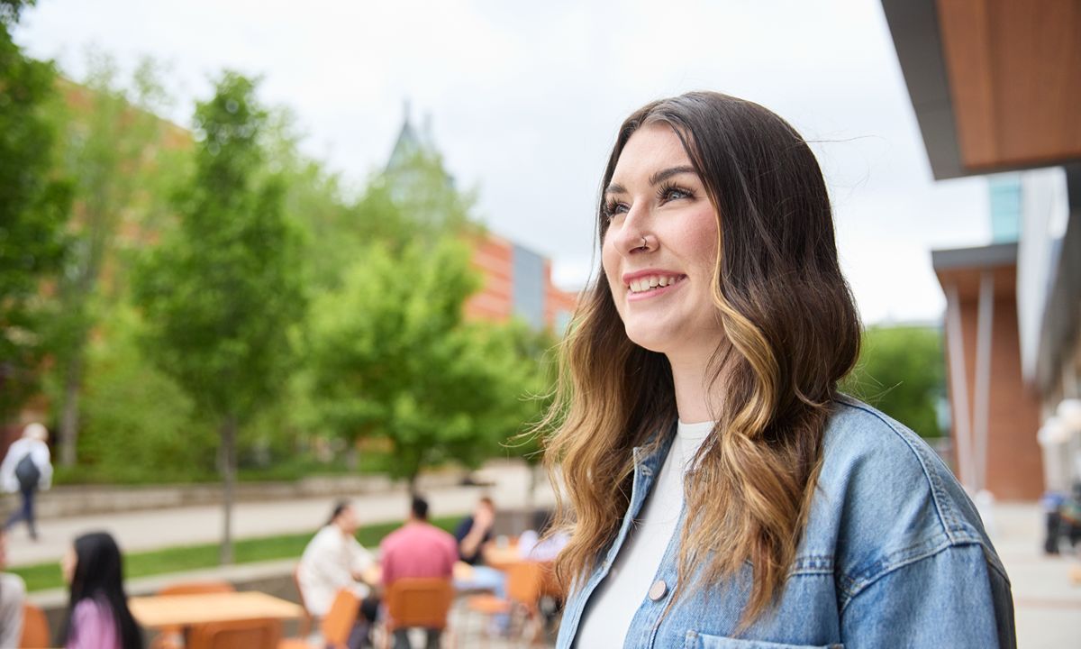 smiling person with campus background