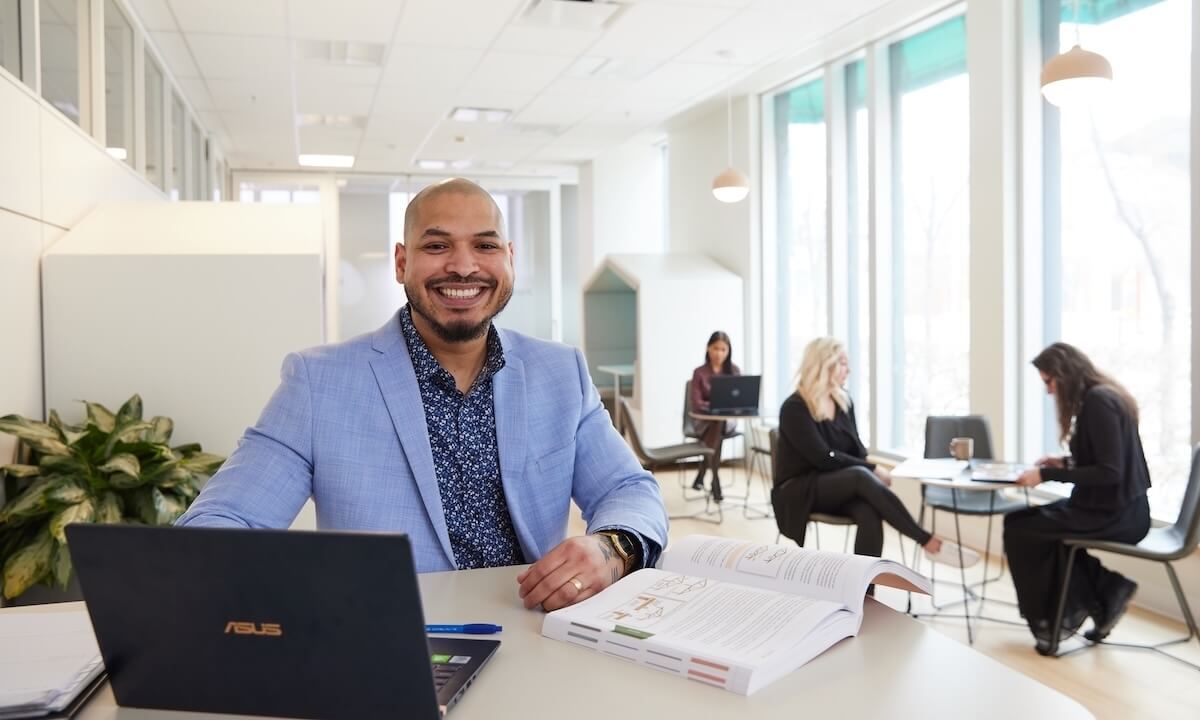 A student sitting in the Continuing Education office learning space