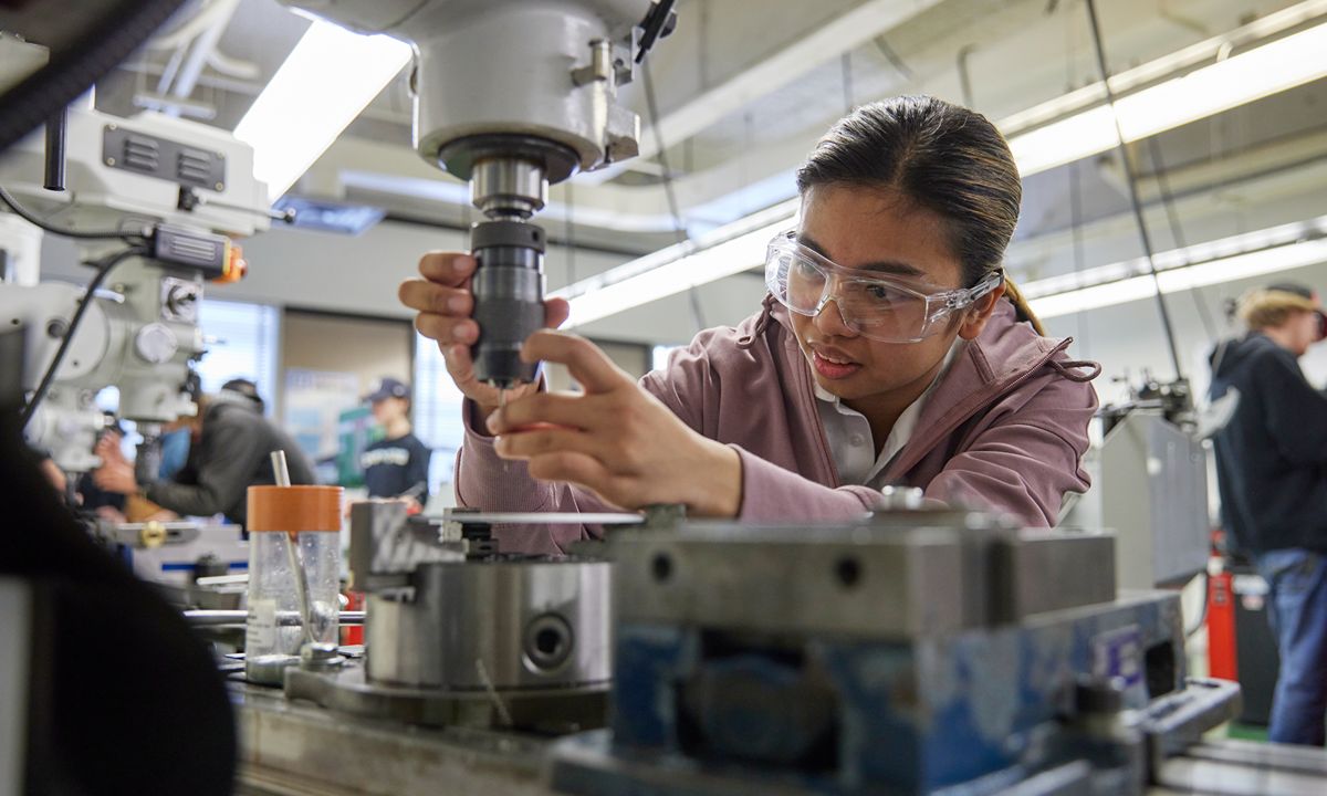student operating milling machine