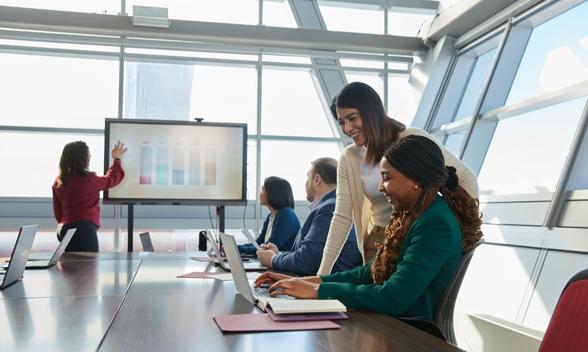 team meeting with data presentation on screen