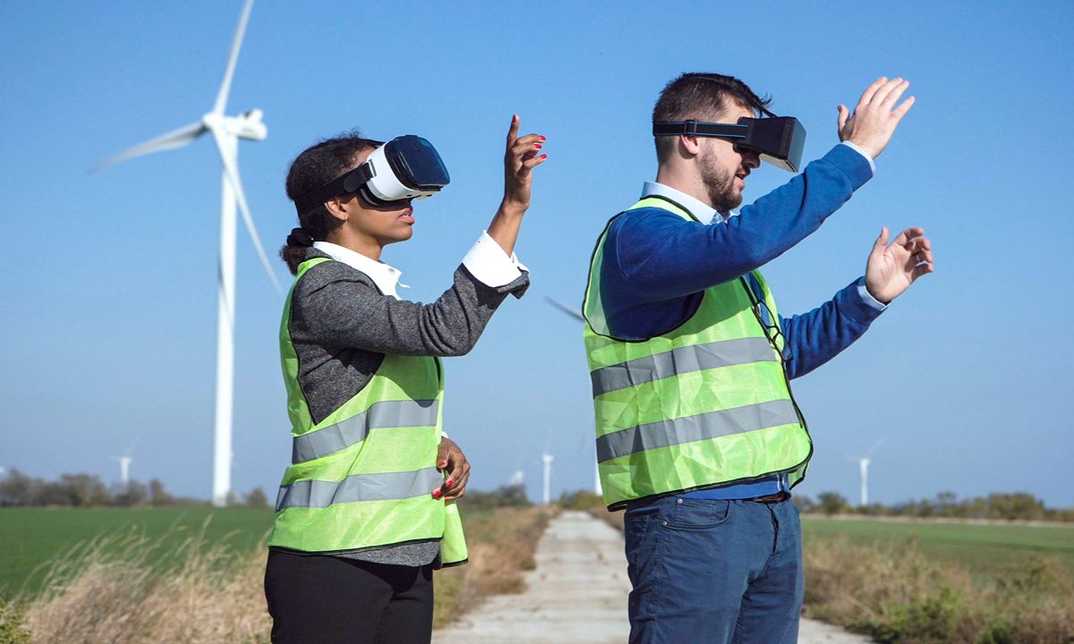 two people in safety vests and vr headsets outside