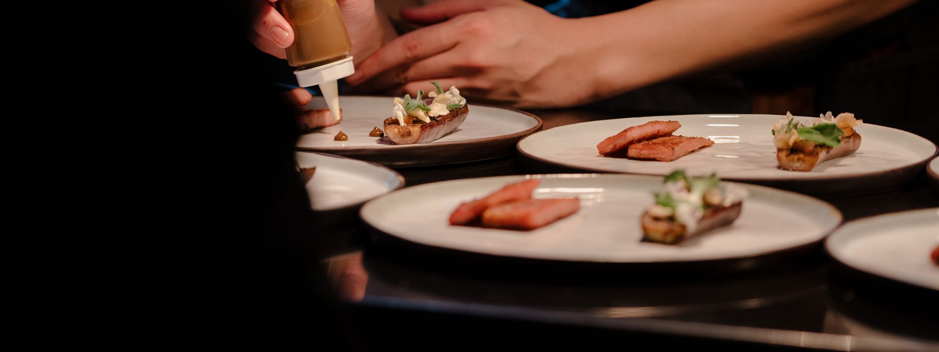 Chef carefully plating gourmet dishes