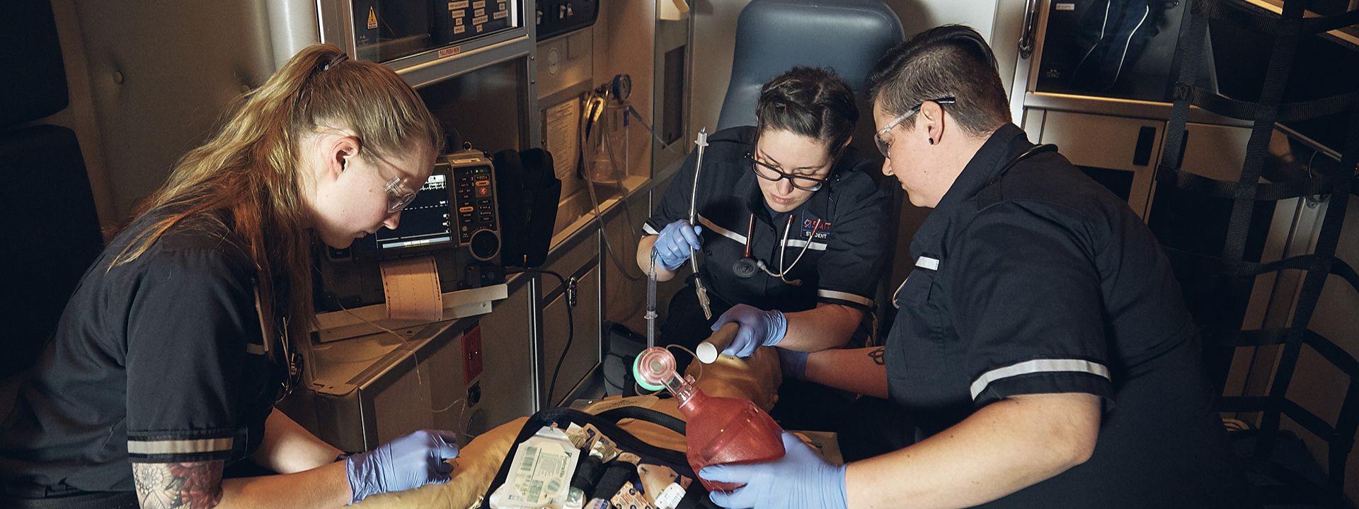 emergency medics performing intubation in ambulance