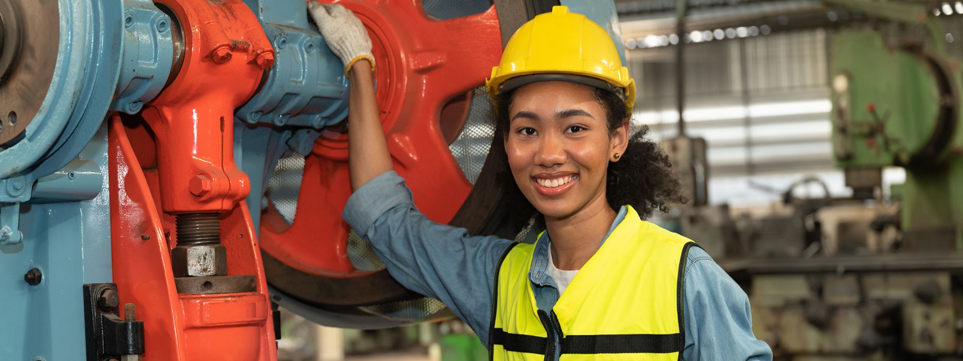 person in hard hat and safety vest holding clipboard