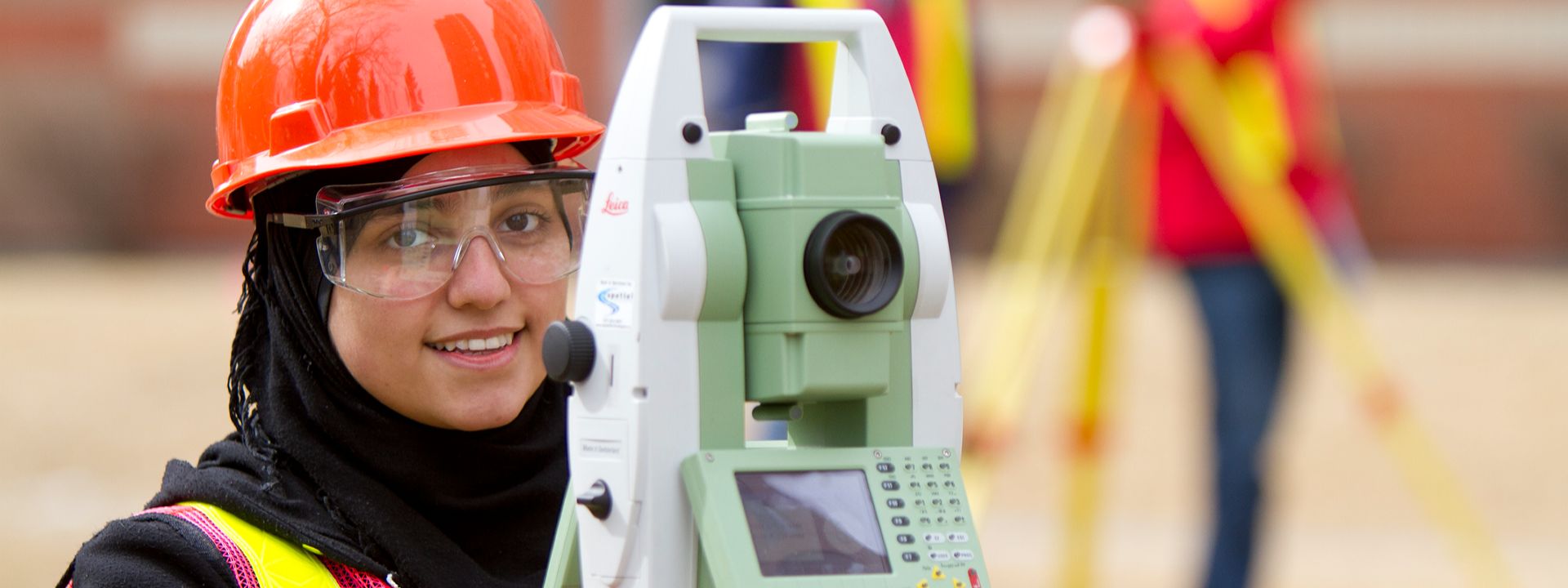 surveyor using total station outdoors