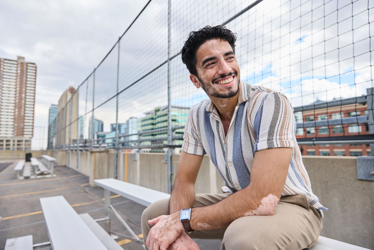 A man sitting on a bench smiling