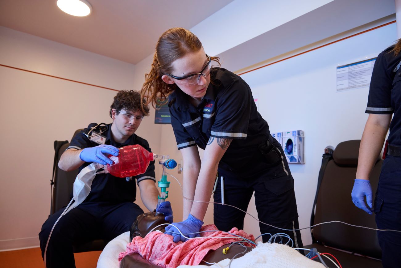 Paramedic students practicing in a simulation room 
