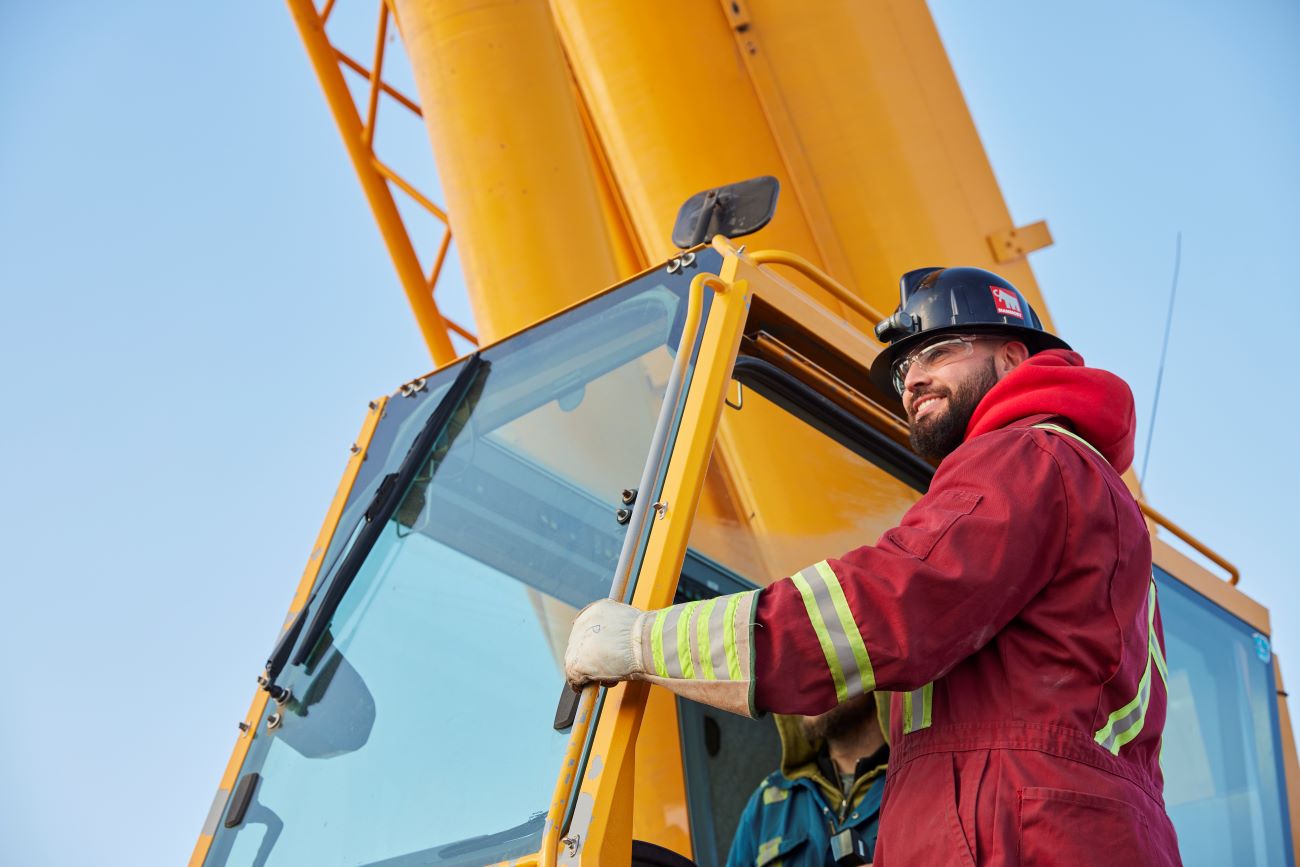 Student wearing safety equipment on a crane