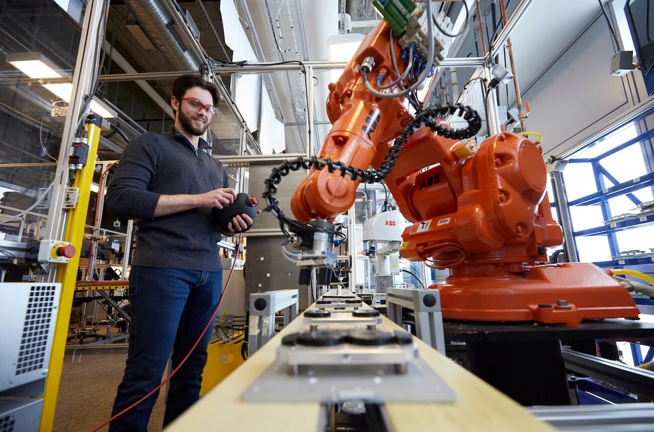 Student working with a robot arm in the lab