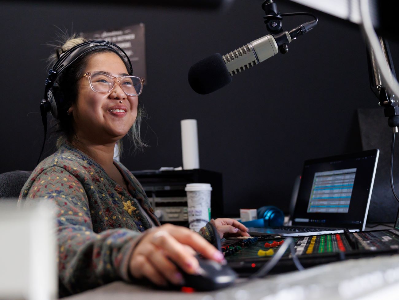A woman working at a professional sound studio
