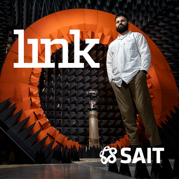 An image of a SAIT alum standing with his hands in his pockets with a white "LINK" logo behind him, featuring a white SAIT logo in the bottom right.