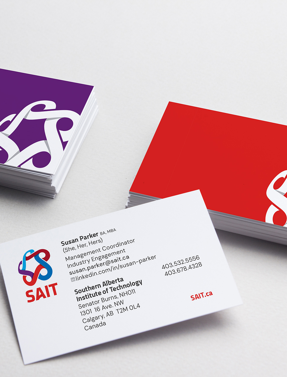 Business cards featuring the logo of SAIT, with contact details for Susan Parker, Management Coordinator.
