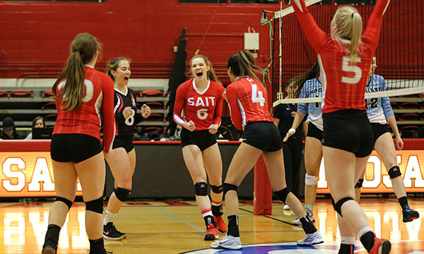 The SAIT women's volleyball team celebrates a win.