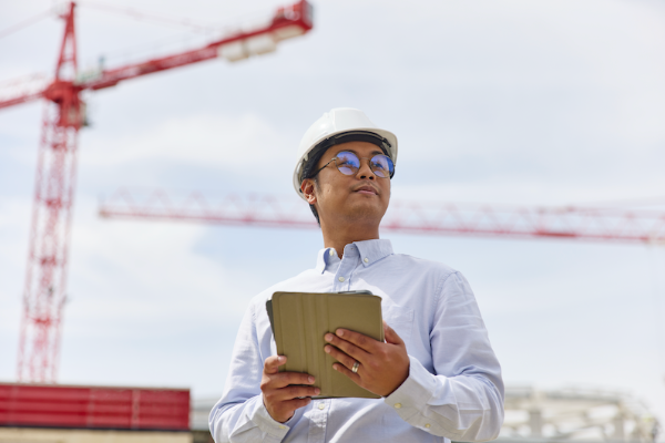 Engineer standing in front of a crane