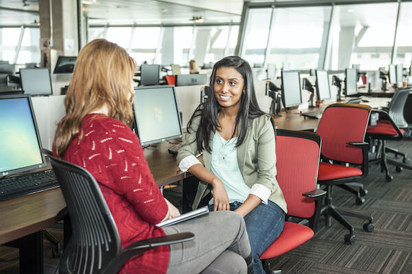 two women sitting in a computer lab