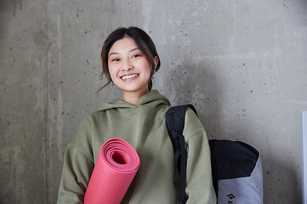 Women holding a yoga mat
