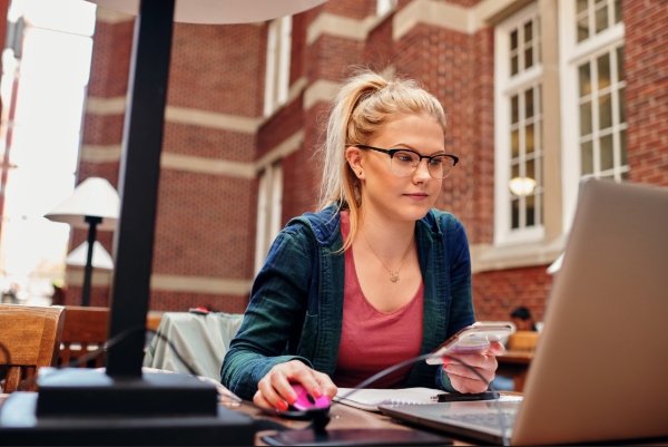 A woman works on a computer in Stan Grad, staring at the screen.