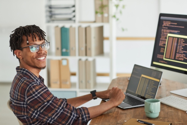 Student working from home, leaning back in a chair at a desk.