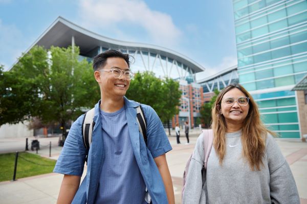 Two people smiling away from the camera