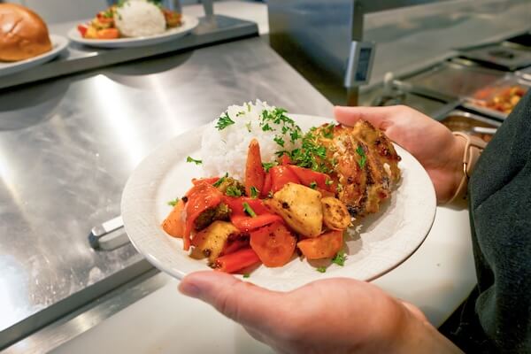 Student holding a plate of food