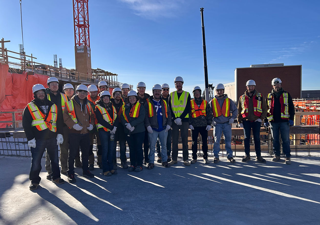 A group of carpentry apprentices and SAIT instructors touring the Taylor Family Campus Centre construction site in January 2026.