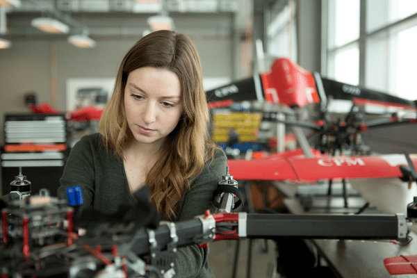 young female researcher working on drone
