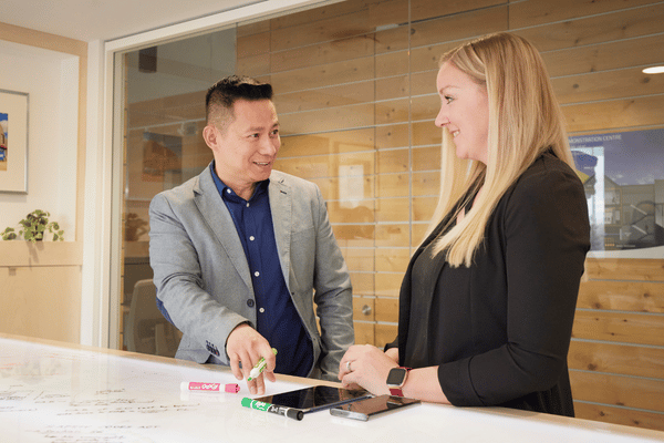 two people talking and working together