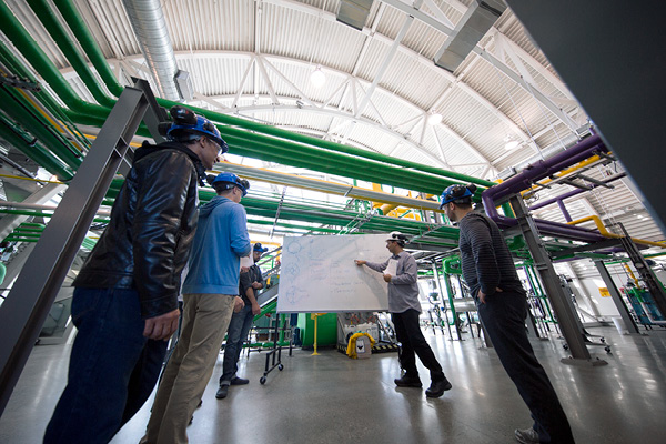 Students watching an instructor discuss while pointing to a white board