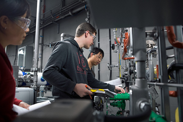 Students looking at gauges