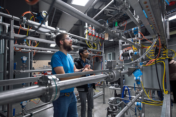Students inside a lab with machines, wires and gauges