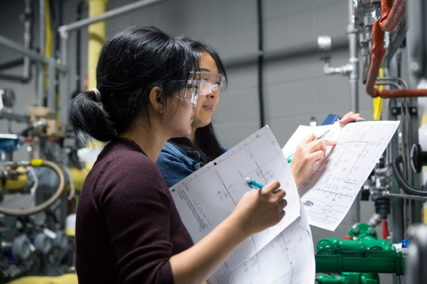 Students filling out a chart in a lab