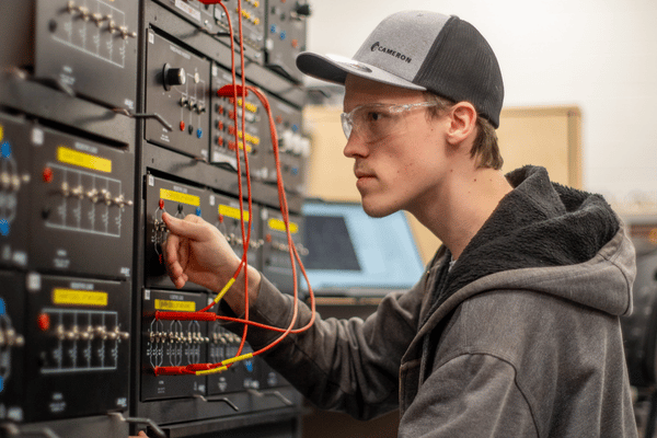 Young man working on electrical board