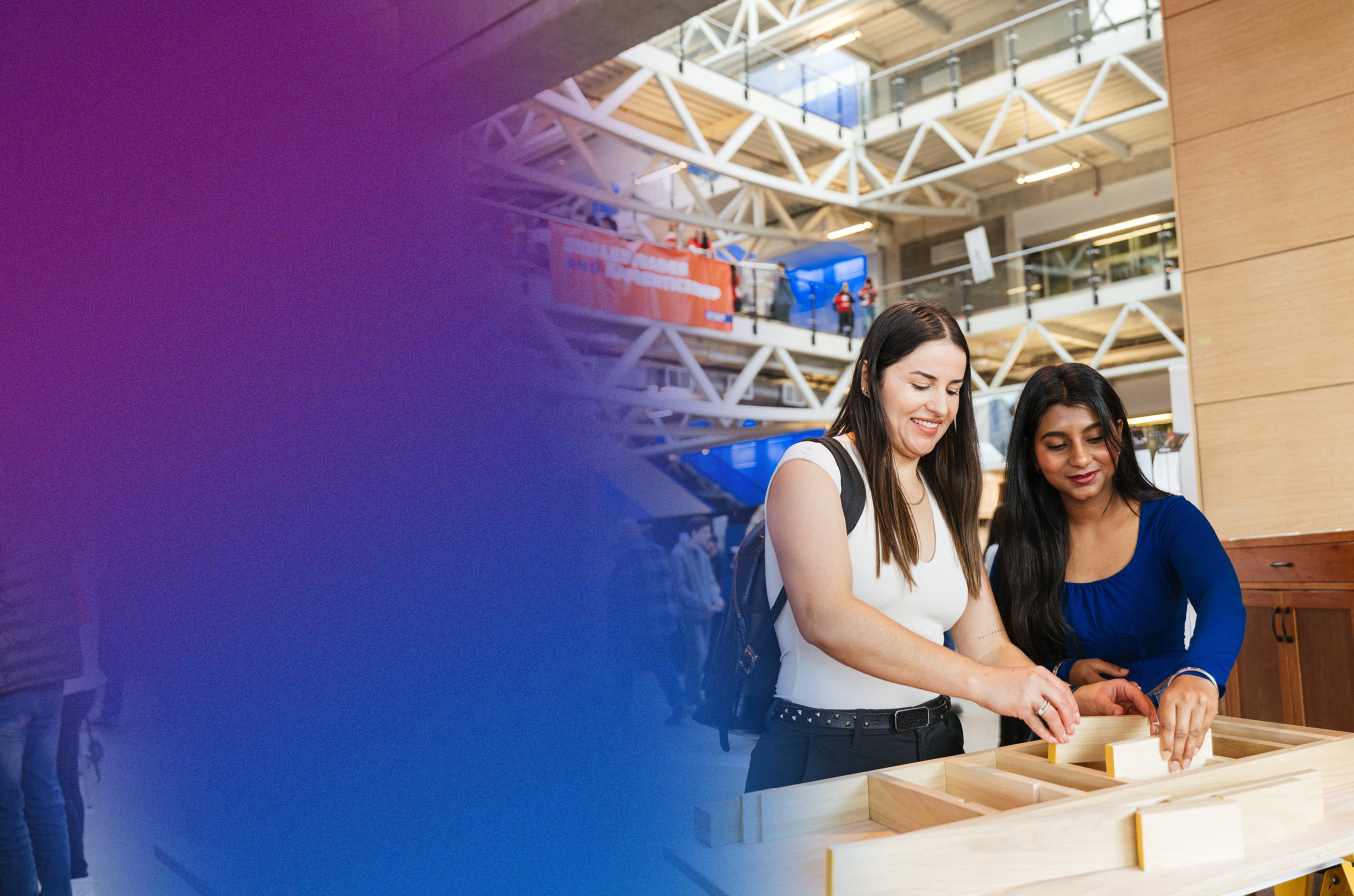 People engaging in a woodworking activity at an event, with a focus on hands-on learning and collaboration.