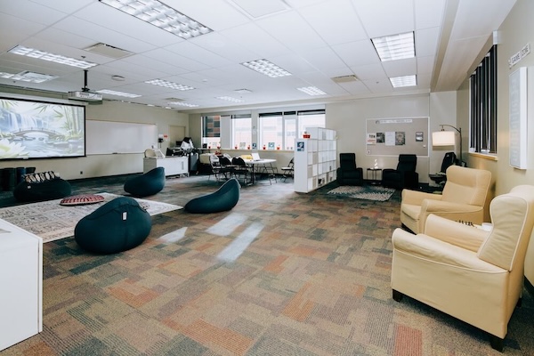 Two large sticky note boards prompt students to add their thoughts.