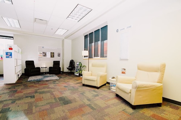 A student paints at a table in the Zen Den.