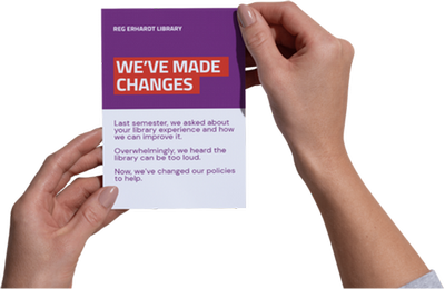 Graphic of someone's hands holding the library brochure entitled "We've made changes"